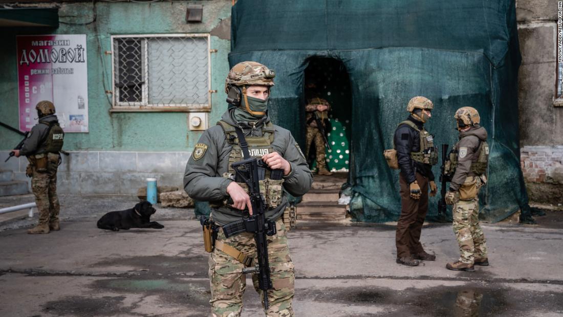 Soldiers stand guard at a military command center in Novoluhanske on February 19.