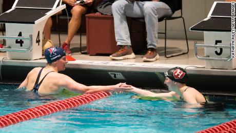 Lia Thomas shakes the hand of Harvard University swimmer Molly Hamlin following the 200-yard freestyle on Friday.