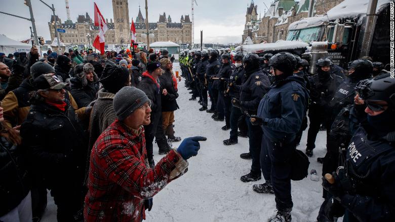 Protesters and police face each other as police move in &lt;a href=&quot;https://www.cnn.com/2022/02/19/americas/canada-trucker-protest-covid-saturday/index.html&quot; target=&quot;_blank&quot;&gt;to clear downtown Ottawa&lt;/a&gt; of protesters on Saturday, February 19.