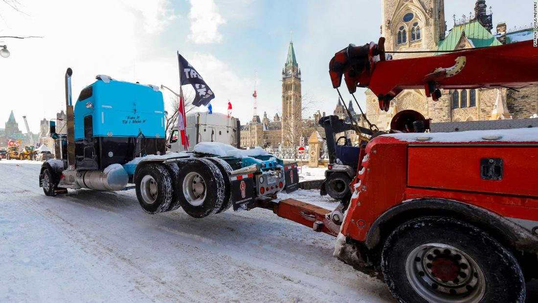 A truck is towed away in front of Ottawa&#39;s Parliament Hill on February 19.