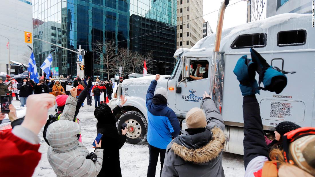 People show their support for a trucker as he leaves downtown Ottawa on February 19.
