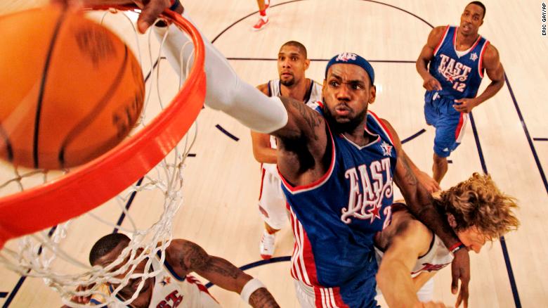 James, of the Cleveland Cavaliers, dunks over Dirk Nowitzki during the All-Star Basketball Game in 2008. 