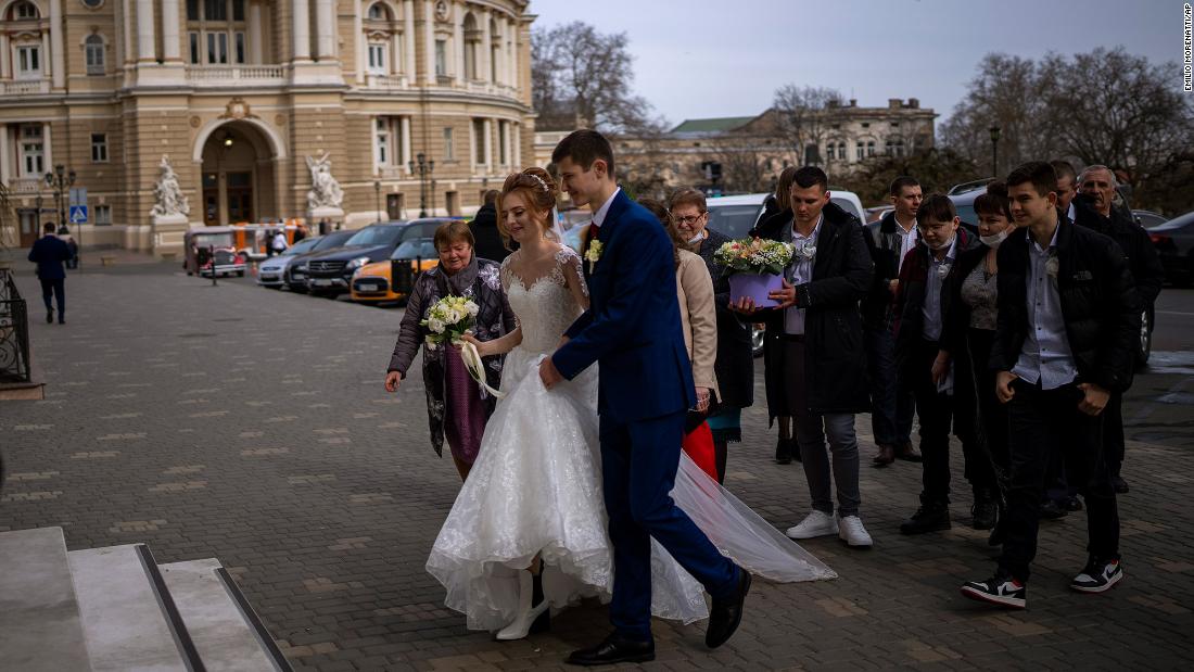 A couple arrives at the city council to get married in Odessa, Ukraine, on February 20. As Ukrainian authorities reported further ceasefire violations and top Western officials warned about an impending conflict, life went on in other parts of the country.