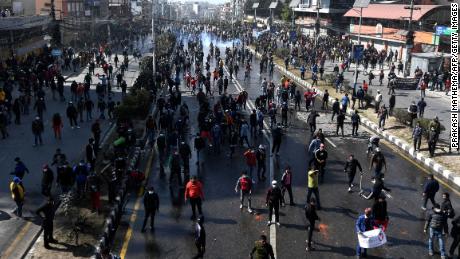 Demonstrators throw stones at police during a protest in Kathmandu, Nepal, on February 20.