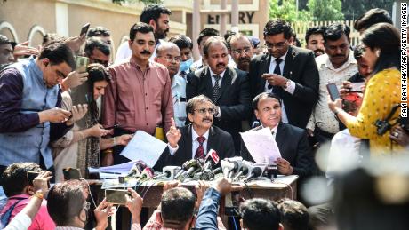 Public prosecutors A.R. Patel (center left) and Sudhir Brahmbhatt (center right) speak to reporters outside the Sessions Court in Ahmedabad, India on February 18.