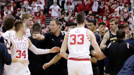 Wisconsin Badgers assistant coach Joe Krabbenhoft reacts after a fight breaks out between Wisconsin and Michigan.
