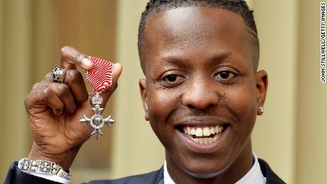 Jamal Edwards holds his Member of the British Empire (MBE), after receiving it from the Prince of Wales at Buckingham Palace on March 26, 2015.