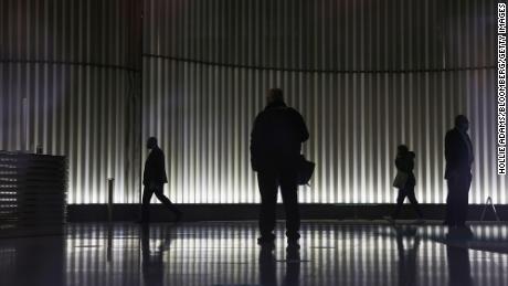 People walk through the lobby of an office building in London in June 2021.