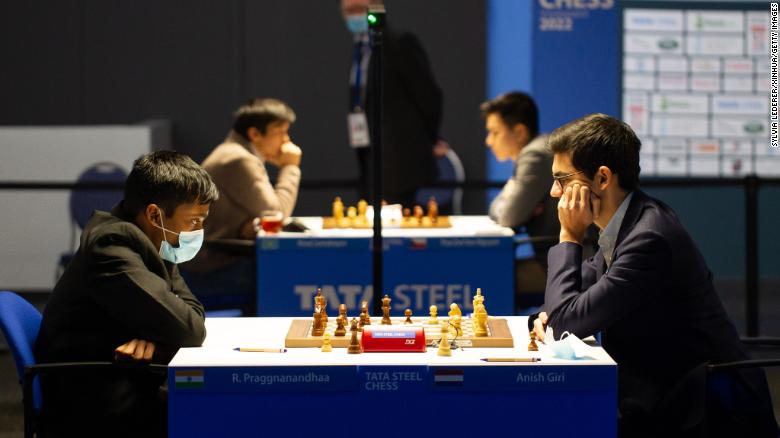 Anish Giri (R) competes against Praggnanandhaa (L) during the 2022 Tata Steel Chess Tournament.