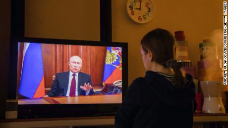 A resident watches a live broadcast of Russian President Vladimir Putin on Monday, Feb. 22.