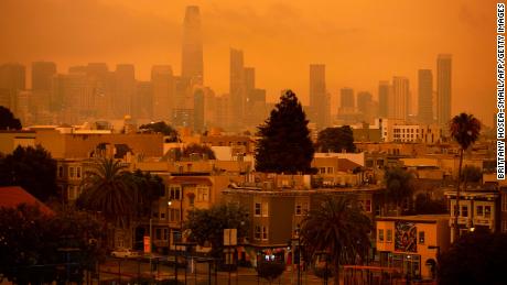 A hazy San Francisco skyline is seen from Dolores Park in September 2020 as more than 300,000 acres burned across the state.