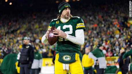 Rodgers throws a pass on the sidelines ahead of a football game in the NFL Division playoffs against the San Francisco 49ers.