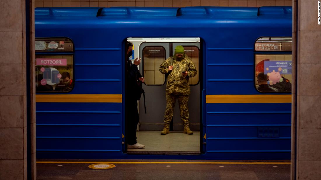 A Ukrainian army officer looks at his phone on a train in Kyiv, Ukraine, on Wednesday, February 23.