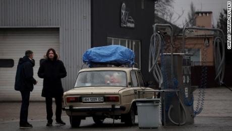 Local residents are seen refueling at a gas station in Mariupol, eastern Ukraine.