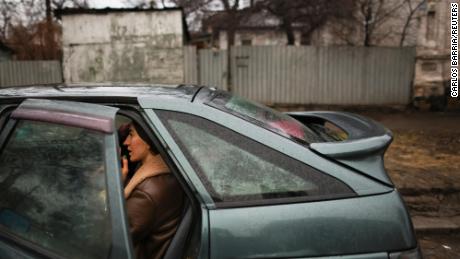 A local resident sits in a car while preparing to leave Mariupol, eastern Ukraine.