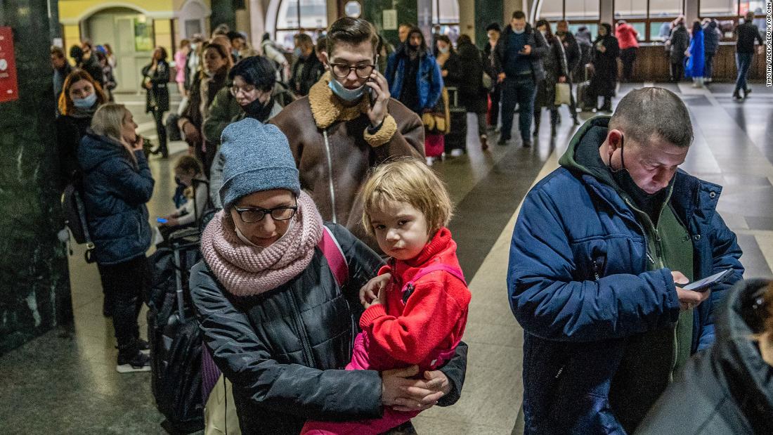 People wait in line to buy train tickets at the central station in Kyiv on February 24.