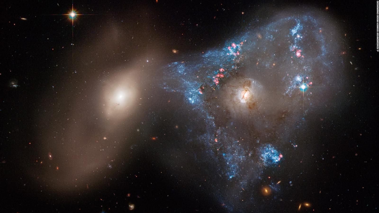 Two galaxies crashing together form unusual space triangle - CNN