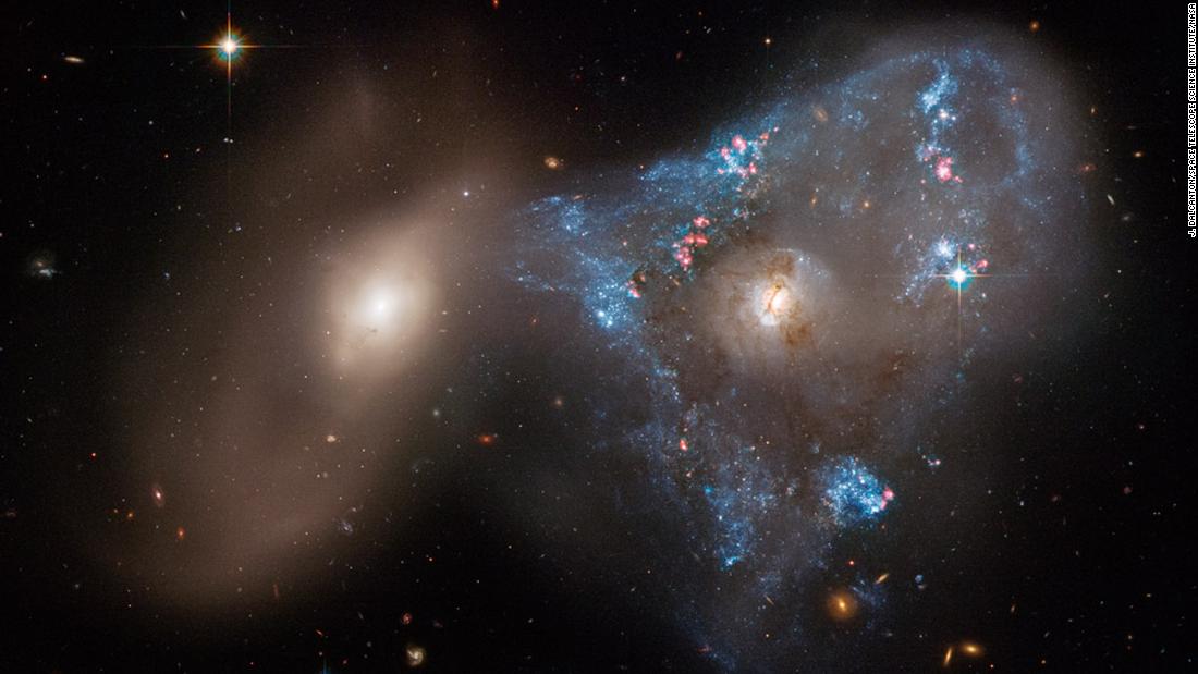 An unusual triangle shape formed by two galaxies crashing together in a cosmic tug-of-war has been captured in a new image taken by NASA&#39;s Hubble Space Telescope. The head-on collision between the two galaxies fueled a star-forming frenzy, creating &quot;the oddball triangle of newly minted stars.&quot;