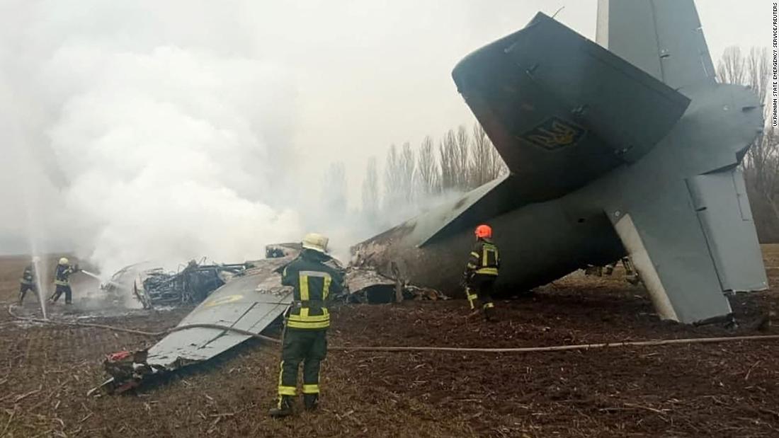 Rescuers work at a crash site on February 24 after a Ukrainian military plane fell and caught fire outside of Kyiv, according to the Ukrainian State Emergency Service. The cause of the crash wasn&#39;t indicated.