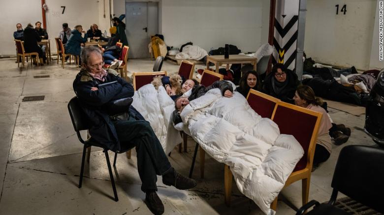 A family takes shelter along with other Kyiv residents in an underground parking garage on Friday. Some areas of the Ukrainian capital were hit by aerial attacks.