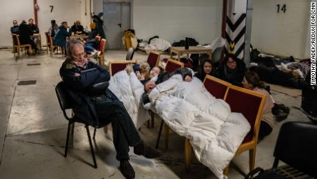 A family takes shelter along with other Kyiv residents in an underground parking garage in Kyiv, Ukraine, Friday, February 25th, 2022. Some areas of Kyiv were hit by aerial attacks.