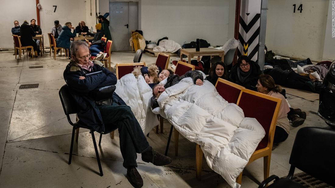 Kyiv residents take shelter in an underground parking garage on February 25.