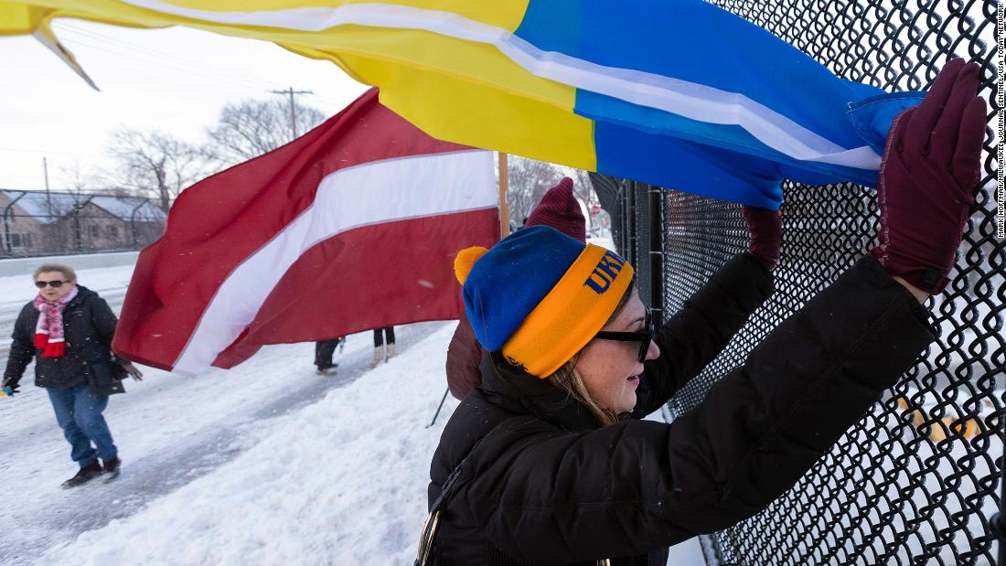 Dozens of people take part in a Stand for Ukraine rally in Milwaukee on February 25.