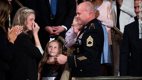Sgt. First Class Townsend Williams greets this wife Amy and their children after a surprise entrance during President Donald Trump&#39;s State of the Union address in the House Chamber on Tuesday, February 4, 2020. 