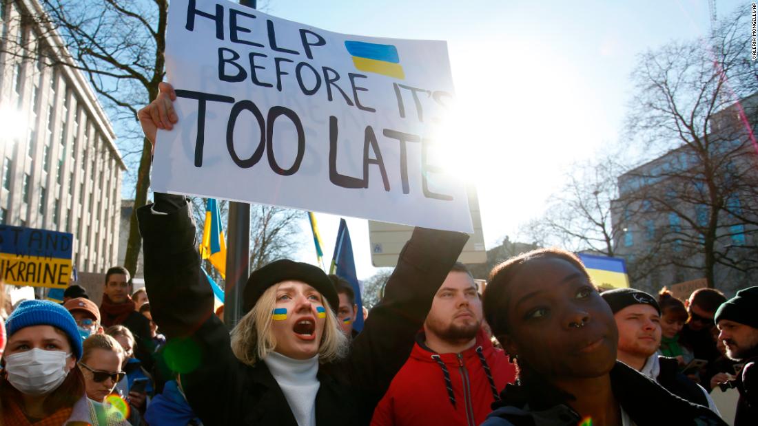 A protester holds a sign that says &quot;help before it&#39;s too late&quot; during a rally in Brussels, Belgium, on February 26.