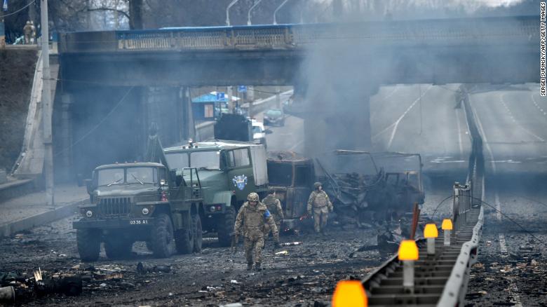 Ukrainian service members are seen at the site of fighting with a Russian raiding group in Kyiv on the morning of February 26, 2022, according to Ukrainian service personnel at the scene.