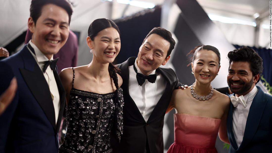 From left, &quot;Squid Game&quot; actors Lee Jung-jae, Jung Ho-yeon, Park Hae-soo, Kim Joo-ryoung and Anupam Tripathi pose for a photo before the show.