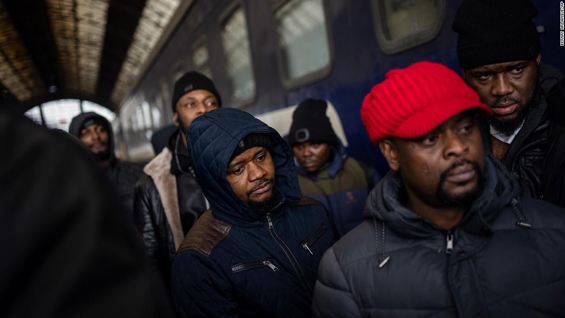 People wait on a platform inside the railway station in Lviv on February 27. Thousands of people at Lviv&#39;s main train station attempted to board trains that would take them out of Ukraine.