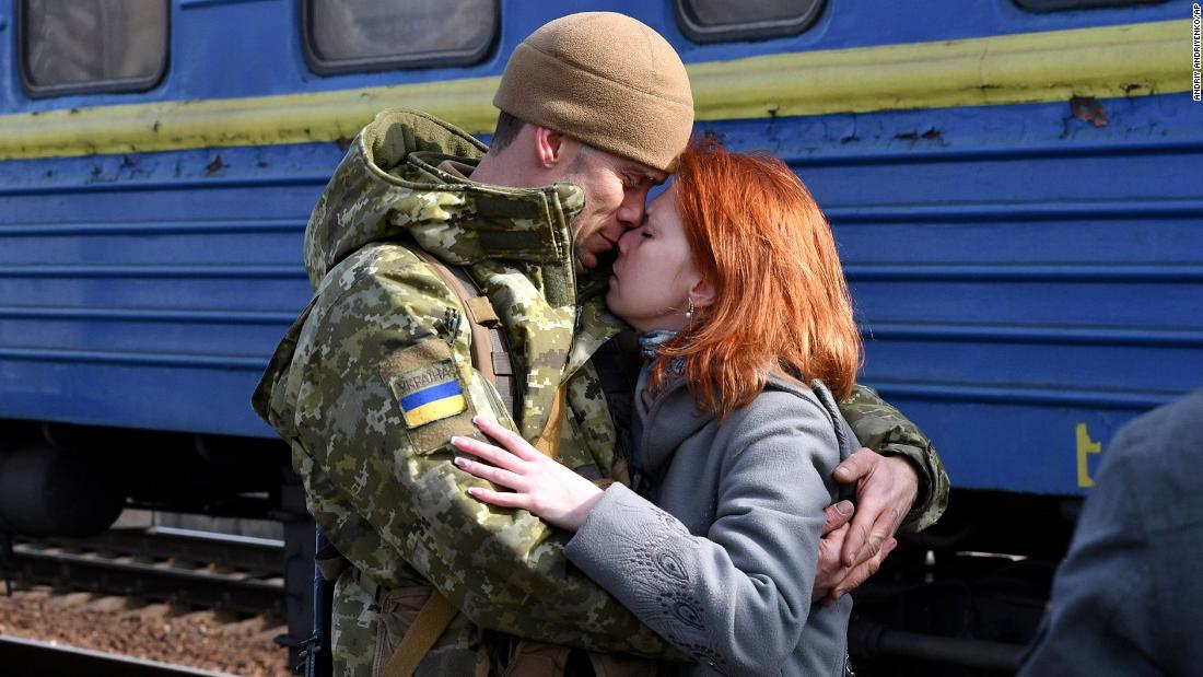 A couple embraces at a railway station in Kramatorsk, Ukraine, on Sunday, February 27. The woman was about to board a train heading west.