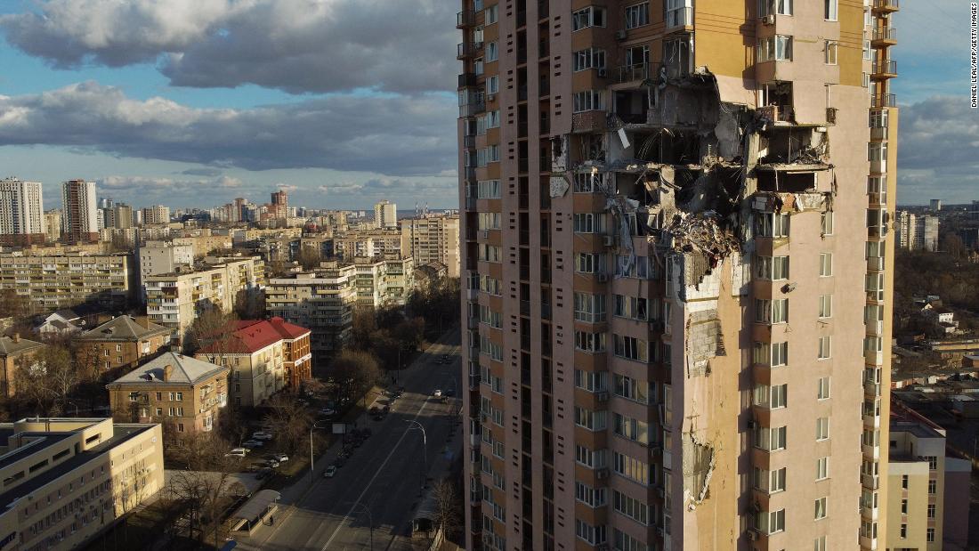 An apartment building in Kyiv is seen after it was damaged by shelling on February 26. The outer walls of several apartment units appeared to be blown out entirely, with the interiors blackened and debris hanging loose. 