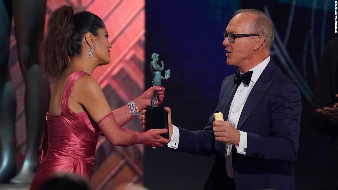 Salma Hayek Pinault presents Michael Keaton with the award for outstanding performance by a male actor in a television movie or limited series. Keaton won for his role in &quot;Dopesick,&quot; Hulu&#39;s compelling recounting of the rise of opioid addiction in America. &lt;a href=&quot;https://www.cnn.com/2022/02/27/entertainment/michael-keaton-sag/index.html&quot; target=&quot;_blank&quot;&gt;Through tears,&lt;/a&gt; he dedicated his award to his sister, Pam, and nephew, Michael, who he said died in 2016 following a battle with drug addiction.