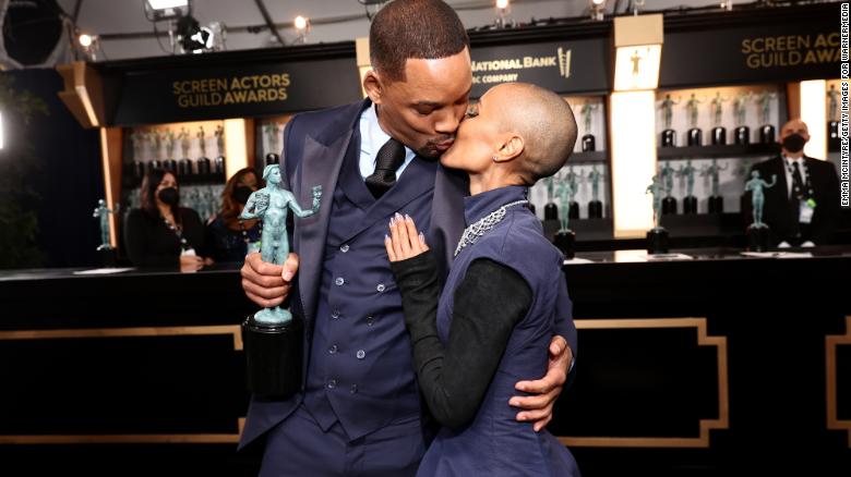 Will Smith kisses his wife, Jada Pinkett Smith, shortly after winning the award for outstanding performance by a male actor in a leading role. He played Richard Williams, the father of tennis greats Serena and Venus Williams, in the film "King Richard." Venus was in the audience with Smith and other cast members, too.