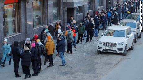 People line up to use an ATM in Saint Petersburg, Russia, February 27, 2022. 