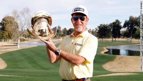 Jimenez poses with the Champion&#39;s trophy following the final round of the Cologuard Classic.