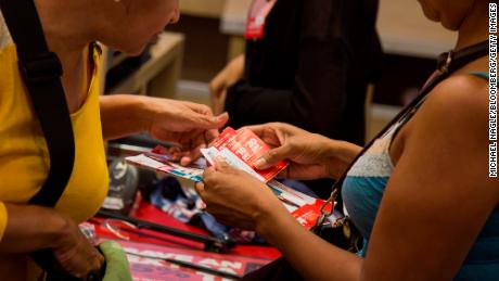 Customers use coupons while purchasing items at the checkout counter of a J.C. Penney Co. store at the Gateway Shopping Center in the Brooklyn borough of New York, U.S., on Saturday, Aug. 8, 2015.