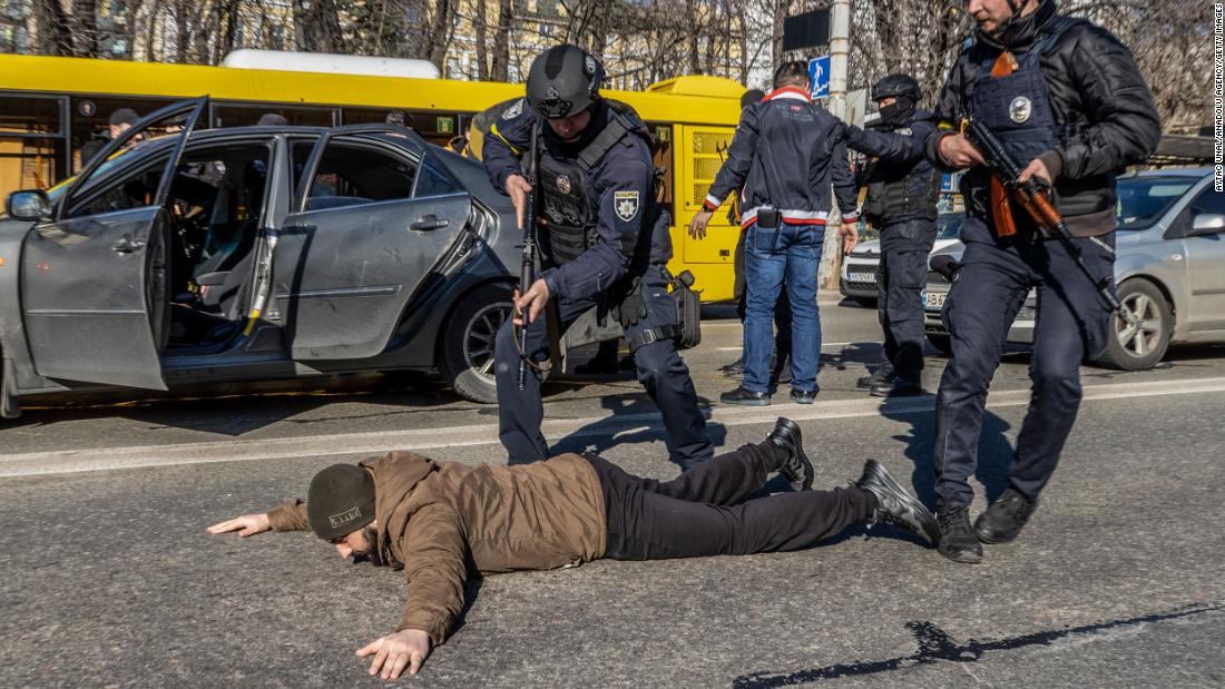 Ukrainian forces order a man to the ground on February 28 as they increased security measures amid Russian attacks in Kyiv.