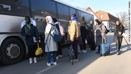 University students, including many from Nigeria, fleeing Ukraine's capital Kyiv stow their luggage as they board their transport bus near the Hungarian-Ukrainian border in the village of Tarpa, Hungary February 28, 2022. 