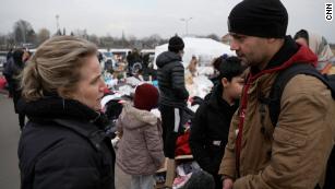 Shock and disbelief brings odd silence as women and children seek refuge in Poland