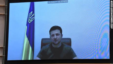 Ukrainian President Volodymyr Zelensky appears on a screen as he speaks during a videoconference. 