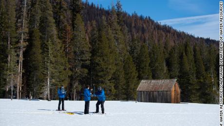 Members of the California Department of Water Resources measure snow totals in the Sierra Nevadas.