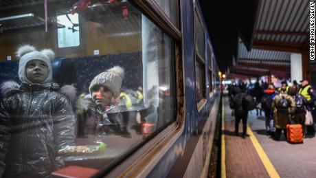 Ukrainian children wear warm jackets and winter hats as they travel aboard a train for refugee relocation on February 28, 2022 in Przemysl, Poland. 