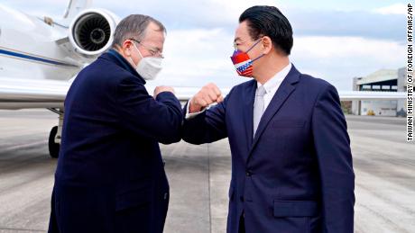 Taiwan&#39;s Foreign Minister Joseph Wu, right, greets former Chairman of the Joint Chiefs of Staff Mike Mullen at Taipei Songshan Airport in Taiwan on March 1, 2022.