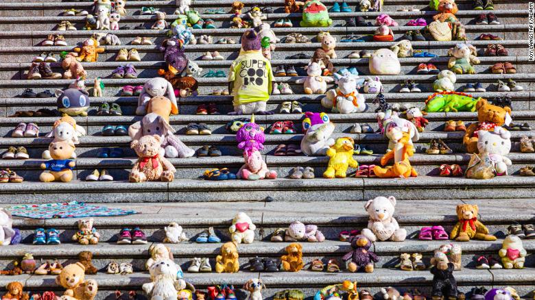 Children&#39;s shoes and toys displayed in Vancouver,  British Columbia, on February 12 representing the hundreds of unmarked graves discovered on the sites of former residential schools in Canada.