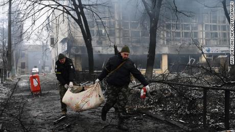 Police Officers Remove The Body Wednesday Of A Passerby Killed In An Airstrike That Hit Kyiv'S Main Television Tower.