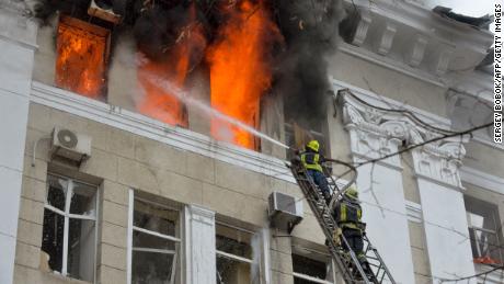 Firefighters work to contain a fire at the complex of buildings housing Kharkiv's SBU regional security service and regional police, which were reportedly hit in recent bombings by Russia, in Kharkiv on March 2, 2022. 