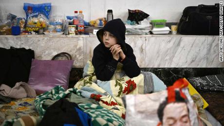 A Boy Sits At An Underground Metro Station Used As Bomb Shelter In Kyiv On March 2, 2023. 
